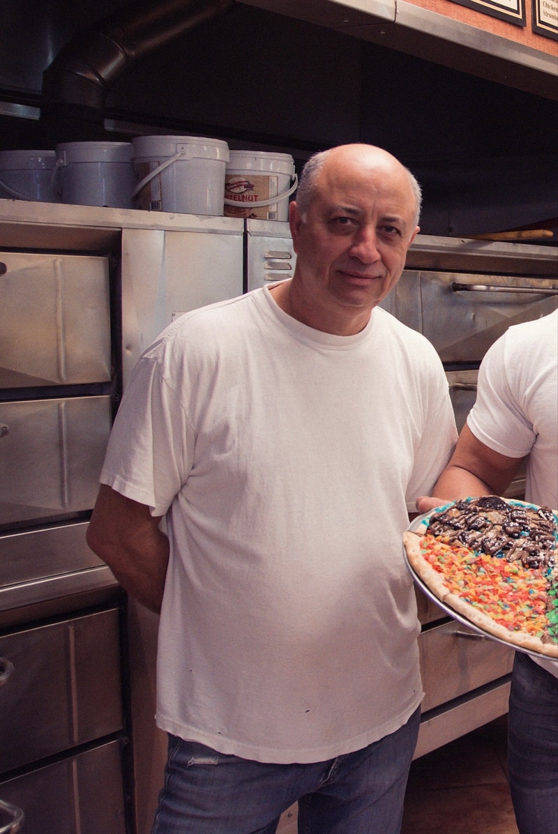 Aniello Mazzella standing in the family pizzeria kitchen