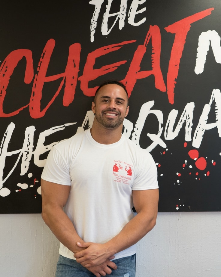 Pietro Mazzella in front of The Cheat Meal Headquarters sign
